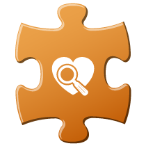 Teal puzzle piece with magnifying glass over heart icon